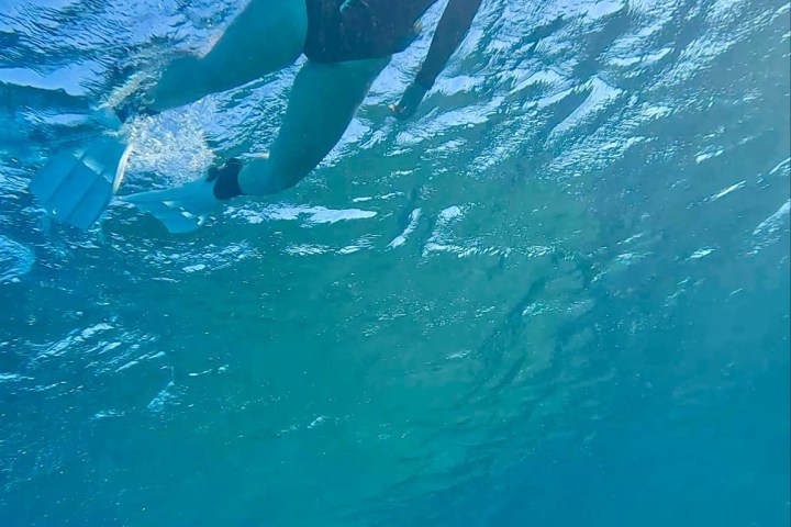 a person riding a wave on a surfboard in the water